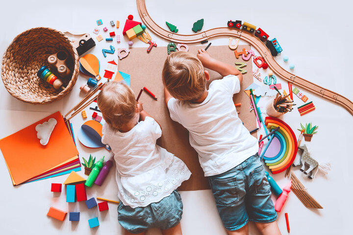Two children coloring on floor